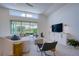 A well-lit living room with a sofa, chairs, and a view of the landscaped backyard at 6504 Virginia Xing, University Park, FL 34201
