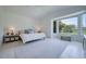 Bright main bedroom featuring a large window with bench, and stylish furnishings at 6504 Virginia Xing, University Park, FL 34201