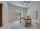 Bright office space with a modern wood desk, accent rug, and serene window view at 6504 Virginia Xing, University Park, FL 34201