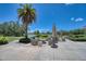 Inviting outdoor seating area with comfortable chairs, umbrellas, and lush landscaping overlooking the serene water view at 6504 Virginia Xing, University Park, FL 34201