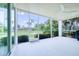 Screened patio with ceiling fan offers outdoor living space with views of the lush backyard at 6504 Virginia Xing, University Park, FL 34201