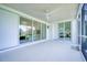 Enclosed patio with ceiling fan and sliding glass doors offering a seamless transition to indoor spaces at 6504 Virginia Xing, University Park, FL 34201