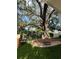 A relaxing backyard area with artificial turf and a mature tree with a swing at 4309 W Beachway Dr, Tampa, FL 33609