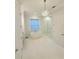 Bright bathroom features a modern tub, glass shower and elegant chandelier at 4309 W Beachway Dr, Tampa, FL 33609