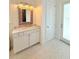 Bathroom featuring stylish vanity with marble countertop, decorative mirror, and mosaic tile flooring at 4309 W Beachway Dr, Tampa, FL 33609