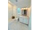 Charming bathroom featuring a glass enclosed shower, stylish tiling, and a decorative mirror at 4309 W Beachway Dr, Tampa, FL 33609