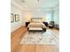 Inviting bedroom with a comfortable bed, chandelier lighting, and hardwood floors at 4309 W Beachway Dr, Tampa, FL 33609
