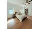 Cozy bedroom featuring hardwood floors, a ceiling fan, and a decorative bed with plush pillows at 4309 W Beachway Dr, Tampa, FL 33609
