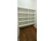 Neat walk-in closet featuring built-in shelves and hardwood floors at 4309 W Beachway Dr, Tampa, FL 33609