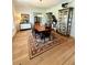 Spacious dining room with a large wooden table, decorative rug, and elegant display cabinets at 4309 W Beachway Dr, Tampa, FL 33609