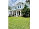 Beautiful white home with a large front lawn and inviting front porch seating at 4309 W Beachway Dr, Tampa, FL 33609