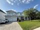 Stunning white modern farmhouse with a three-car garage and meticulously landscaped front yard at 4309 W Beachway Dr, Tampa, FL 33609