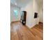Hallway with hardwood floors, decorative calendar, and white trim at 4309 W Beachway Dr, Tampa, FL 33609