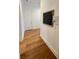 Hallway with hardwood floors, decorative calendar, and white trim at 4309 W Beachway Dr, Tampa, FL 33609
