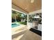 Covered outdoor kitchen with a stainless steel grill and sink overlooking a lush backyard at 4309 W Beachway Dr, Tampa, FL 33609