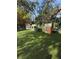 Fun backyard with multiple playhouses and a dinosaur for ' entertainment at 4309 W Beachway Dr, Tampa, FL 33609