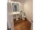 Clean powder room with modern fixtures, pedestal sink, and hardwood flooring at 4309 W Beachway Dr, Tampa, FL 33609