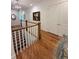 Hardwood floors lead to the second level with wood and white railing at 4309 W Beachway Dr, Tampa, FL 33609