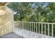 Balcony with white railings offers a view of lush green trees at 11239 Cedar Hollow Ln, Tampa, FL 33618