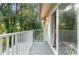 View of a private balcony overlooking mature trees and greenery at 11239 Cedar Hollow Ln, Tampa, FL 33618