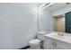 Bright bathroom with a toilet, a light fixture, and a white vanity at 11239 Cedar Hollow Ln, Tampa, FL 33618