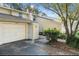 A bright two-story home with a one car garage and manicured landscaping at 11239 Cedar Hollow Ln, Tampa, FL 33618