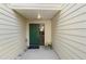 Inviting front entrance featuring a green door with a glass side panel at 11239 Cedar Hollow Ln, Tampa, FL 33618