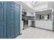 White kitchen features stainless appliances, granite counters, and view to living room at 11239 Cedar Hollow Ln, Tampa, FL 33618