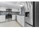 Bright kitchen featuring stainless steel appliances, white cabinets and stylish backsplash at 11239 Cedar Hollow Ln, Tampa, FL 33618