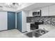 Bright kitchen features modern appliances, sleek cabinetry, and an eye-catching mosaic backsplash at 11239 Cedar Hollow Ln, Tampa, FL 33618