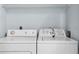 A well-lit laundry room equipped with a side-by-side washer and dryer at 11239 Cedar Hollow Ln, Tampa, FL 33618