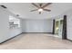 Bright living room with tile flooring, ceiling fan and sliding glass doors at 11239 Cedar Hollow Ln, Tampa, FL 33618