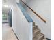 Staircase with hardwood treads and modern blue painted risers and trim at 11239 Cedar Hollow Ln, Tampa, FL 33618