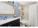 Bathroom features a modern vanity, designer wallpaper, and shower-tub combo with tiled walls at 265 Seahorse Se Dr # B, St Petersburg, FL 33705