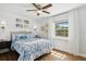 Cozy bedroom with a wood accent wall, ceiling fan and lots of natural light at 265 Seahorse Se Dr # B, St Petersburg, FL 33705