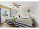 Bright bedroom with two twin beds, ceiling fan, and light neutral walls at 265 Seahorse Se Dr # B, St Petersburg, FL 33705
