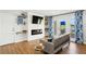 Bright living room with decorative fireplace and lake views through the sliding door at 265 Seahorse Se Dr # B, St Petersburg, FL 33705