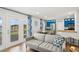 Cozy living room with lake view, open to a kitchen with modern blue cabinets at 265 Seahorse Se Dr # B, St Petersburg, FL 33705