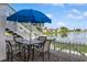 Outdoor patio with table and chairs overlooks a serene lake at 265 Seahorse Se Dr # B, St Petersburg, FL 33705