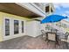Paver patio has an outdoor table and chairs, with stairs leading to the upper level, perfect for entertaining at 265 Seahorse Se Dr # B, St Petersburg, FL 33705