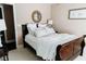 Relaxing bedroom with a beach-themed decor, a dark wood sleigh bed, and soft linens at 9221 Mountain Magnolia Dr, Riverview, FL 33578