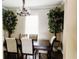 Dining room featuring light walls, hardwood floors, and an elegant chandelier over the table at 9221 Mountain Magnolia Dr, Riverview, FL 33578