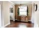 Dining area featuring dark hardwood flooring, light tan walls, and a decorative wooden sideboard at 9221 Mountain Magnolia Dr, Riverview, FL 33578