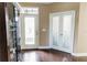 A bright entryway with hardwood floors, double glass doors, and a clear view of the front door at 9221 Mountain Magnolia Dr, Riverview, FL 33578