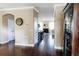 Hallway with hardwood floors leading to a kitchen, dining area, and sitting room at 9221 Mountain Magnolia Dr, Riverview, FL 33578