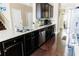 Well-lit kitchen with dark cabinets, stainless steel appliances, and granite countertops, perfect for cooking and entertaining at 9221 Mountain Magnolia Dr, Riverview, FL 33578
