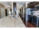 Spacious kitchen with dark cabinets and granite countertops, offering ample space for food preparation at 9221 Mountain Magnolia Dr, Riverview, FL 33578