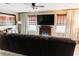 Inviting living room featuring a fireplace and large television, perfect for cozy evenings at 9221 Mountain Magnolia Dr, Riverview, FL 33578