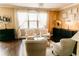 Bright living room with comfortable seating, large windows, and decorative lighting at 9221 Mountain Magnolia Dr, Riverview, FL 33578