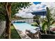 Beautiful in-ground pool with lounge seating and serene lake view, ideal for relaxation and outdoor enjoyment at 9221 Mountain Magnolia Dr, Riverview, FL 33578